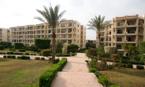 Inside the gated compound Zayed 2000, carefully tended landscaping creates a contrast with the barren ground in public spaces