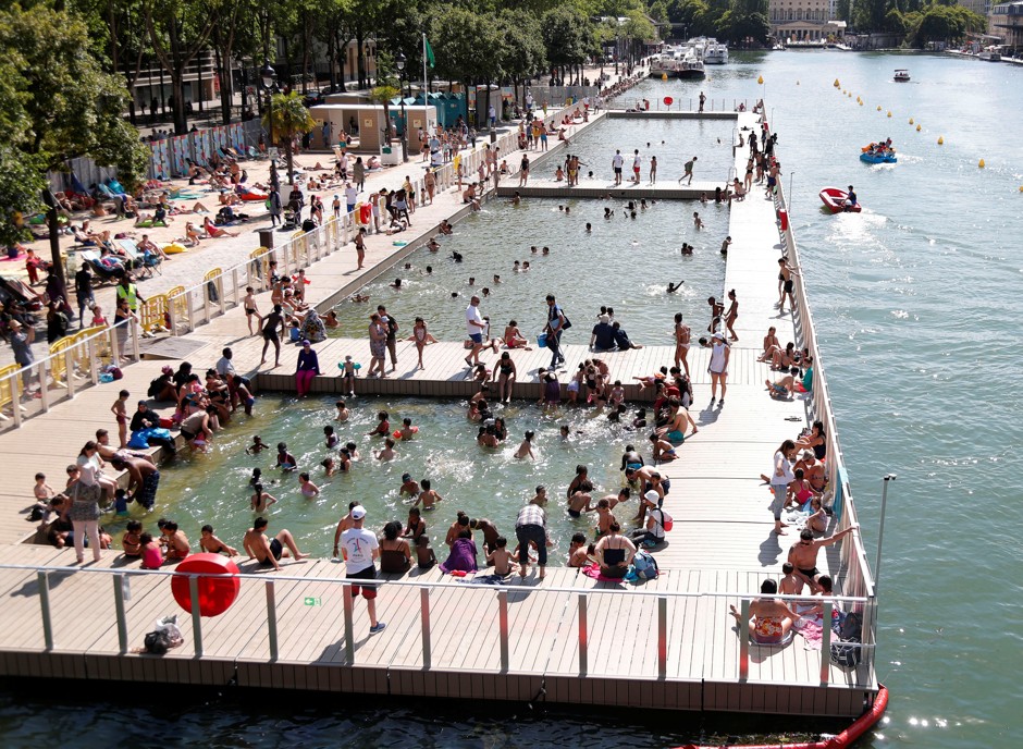 People enjoy the three swimming areas open up along the Bassin de la Villette, as part of the Paris Plages summer festival in Paris